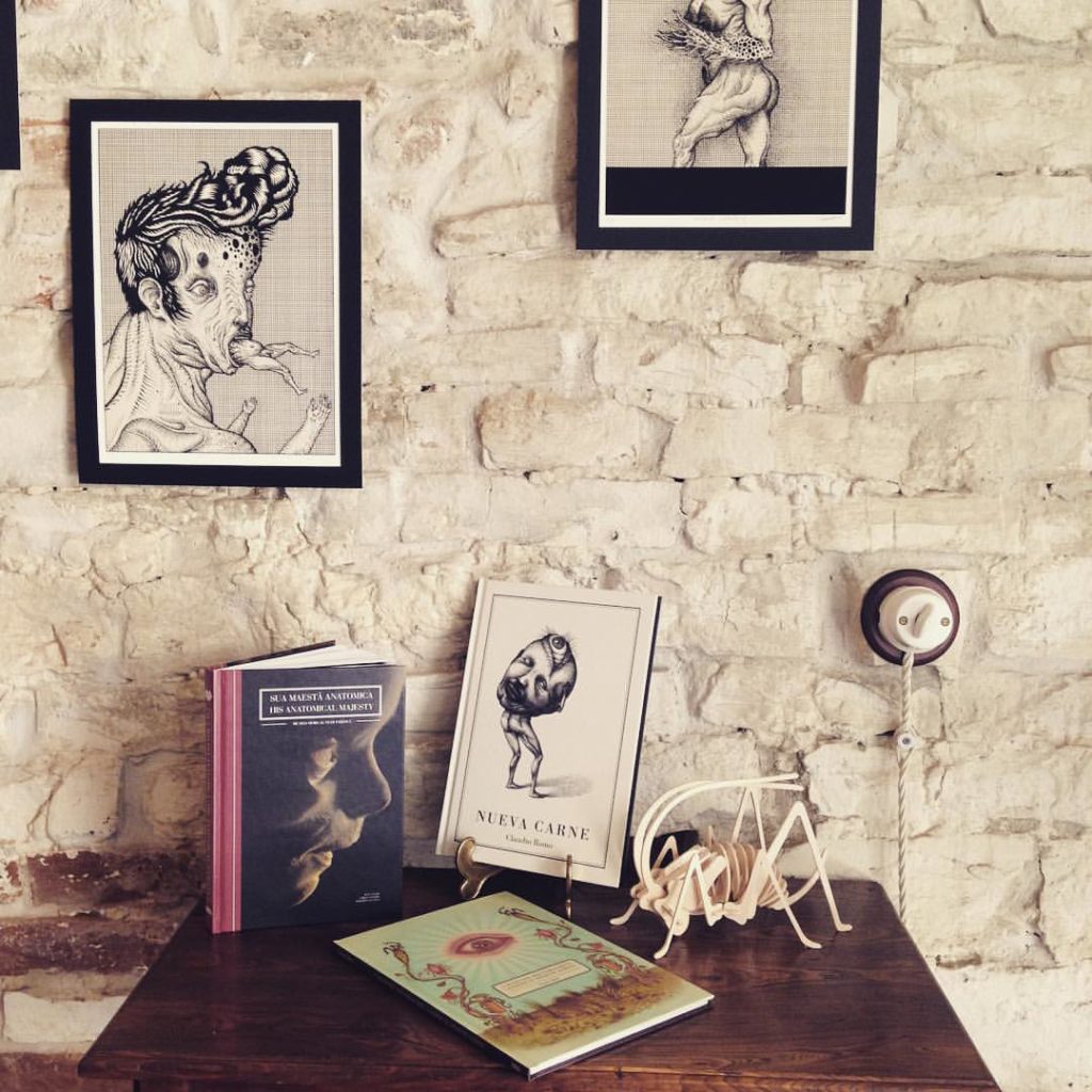 Picture of a book rack placed against a white bricked wall. 