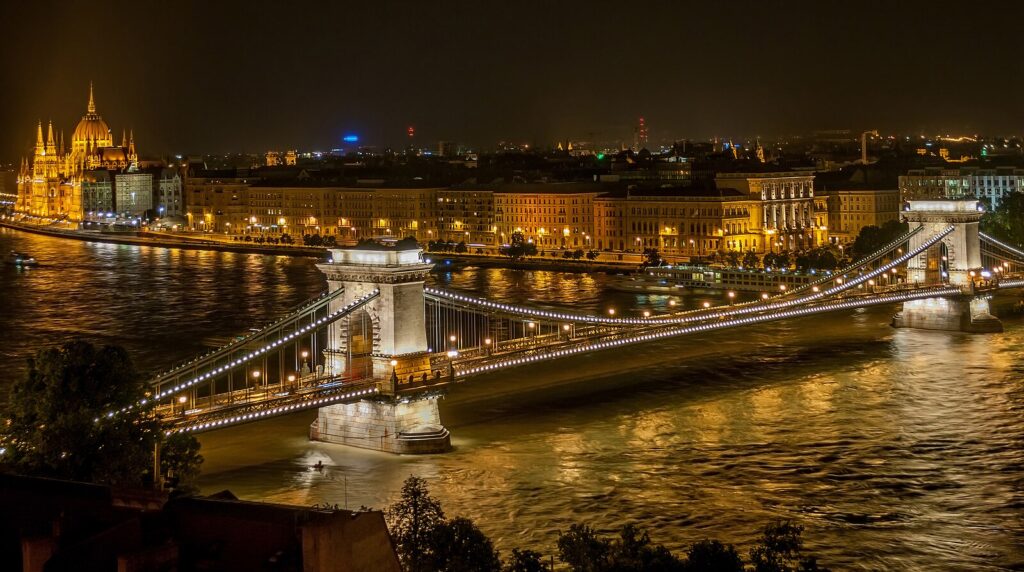 Picture of the Budapest chain bridge and parliament building at night.