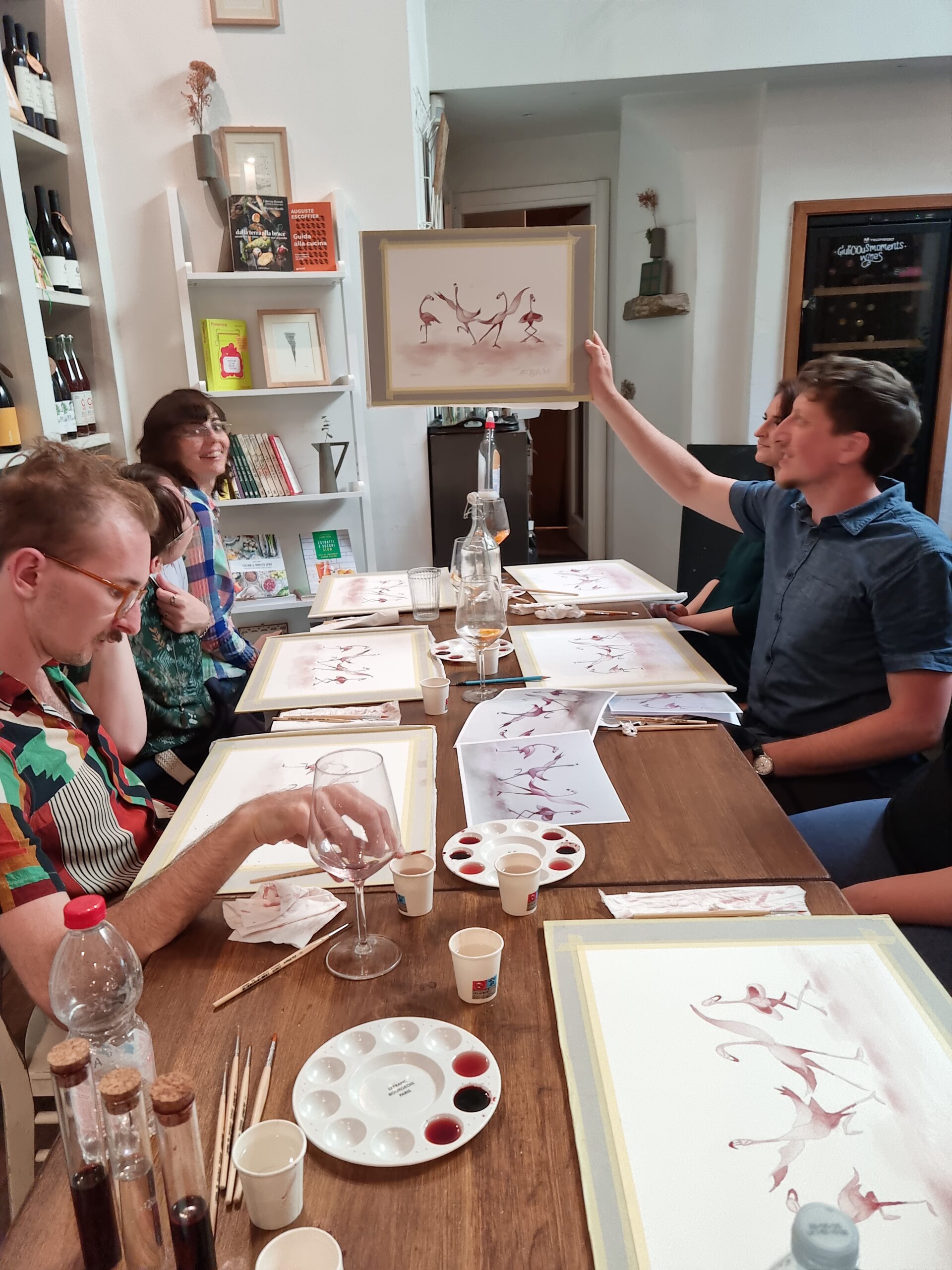 A group of young adults painting with wine.