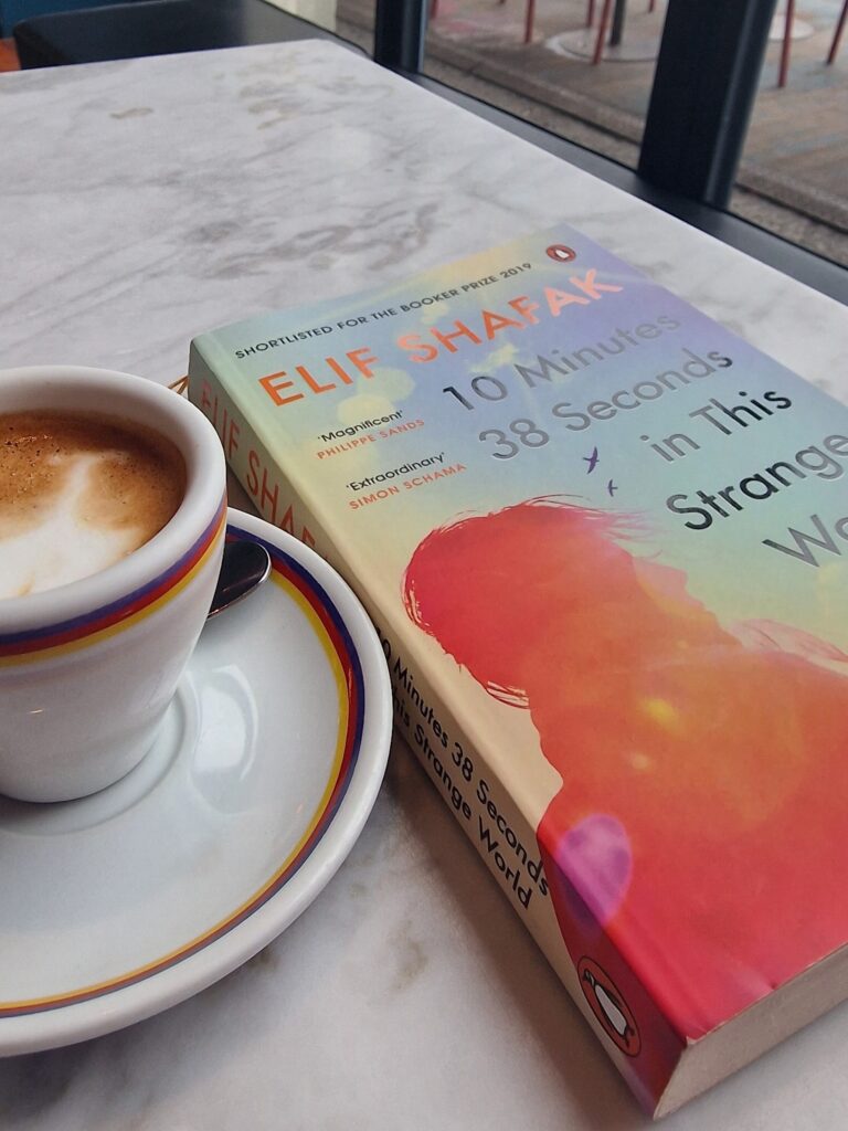 A picture of a book and espresso cup. 