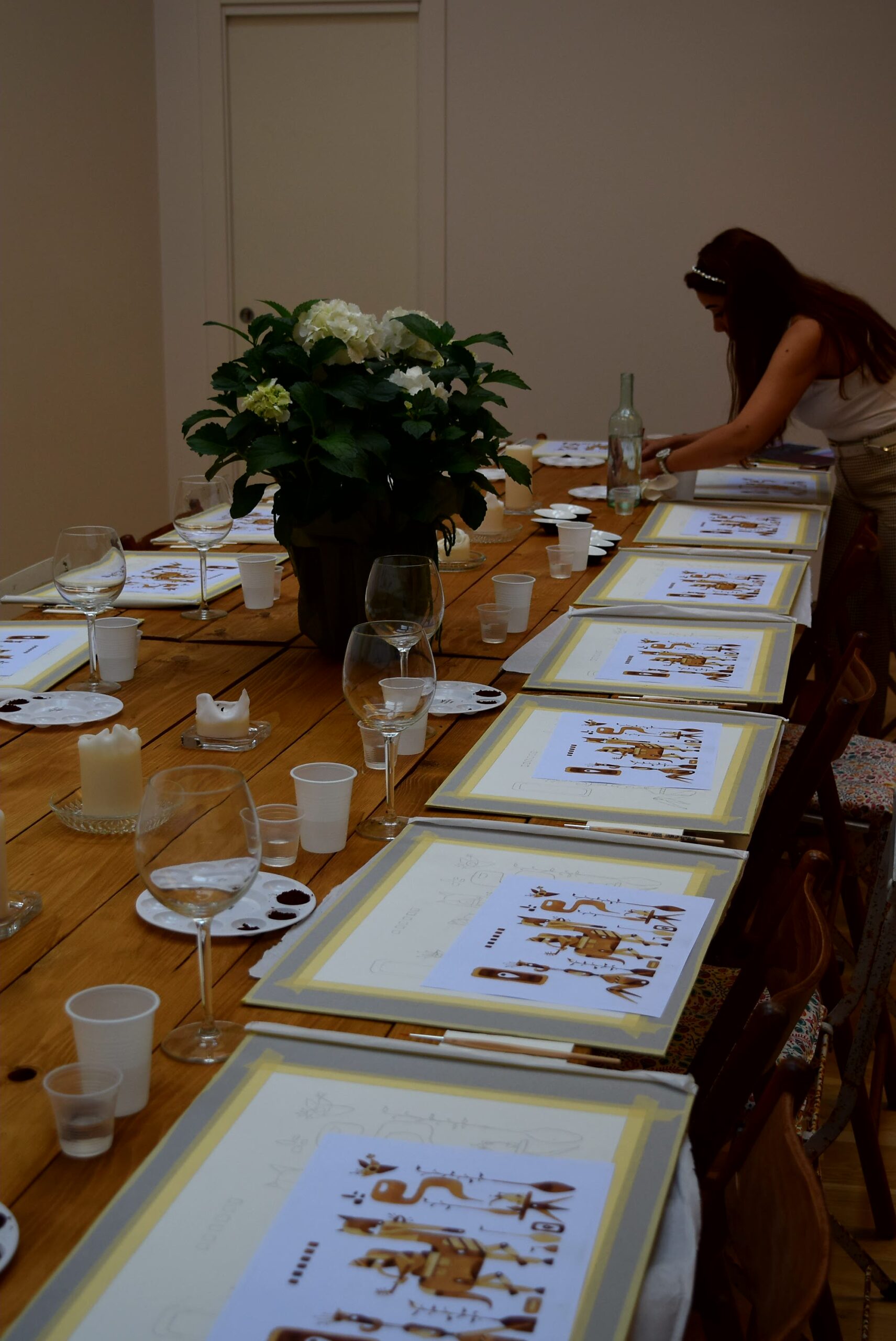 A long table all set for a painting event.