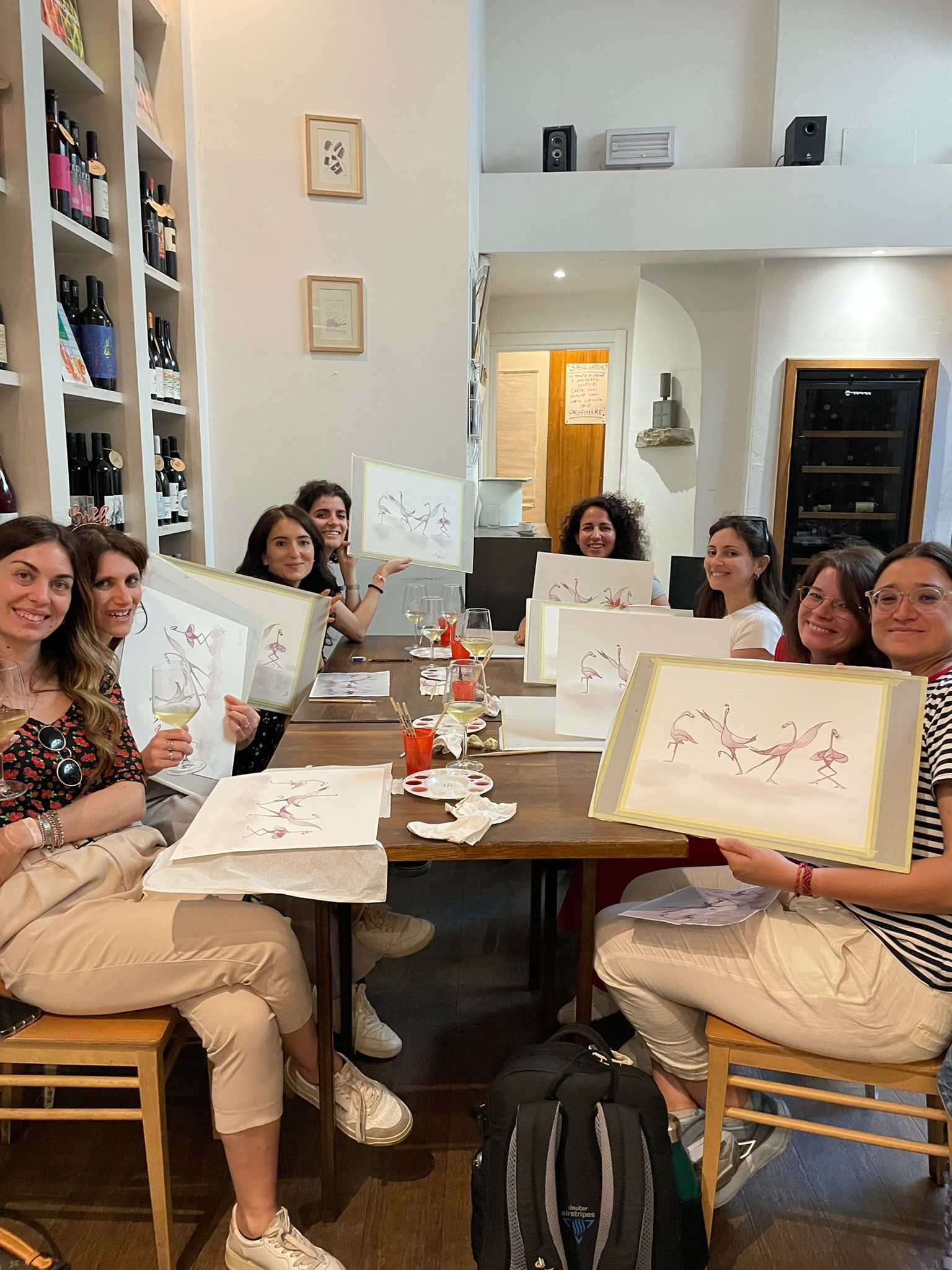 A group of girls showing their paintings.