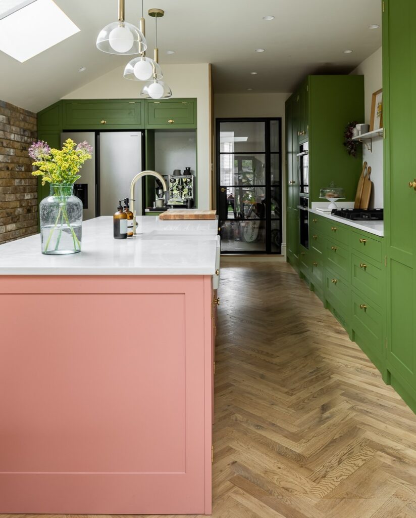 Picture of a green and pink farmhouse style kitchen. 