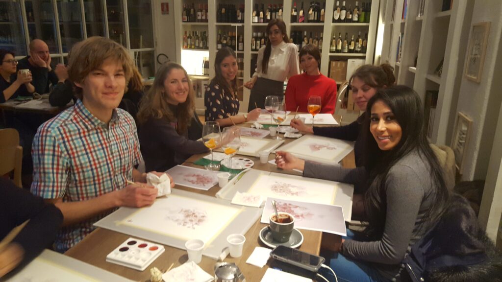 A group of participants sitting together for Sip & Dip Art Experience. 