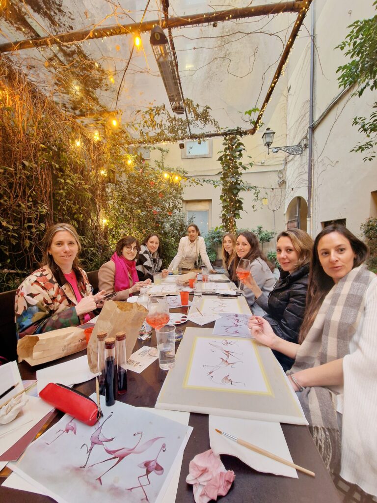 Sip & Dip Painting with Wine event, picture of 7 girls with the host. 