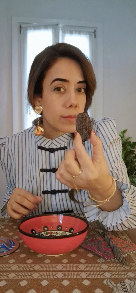 Picture of the author showing a Medjool date.