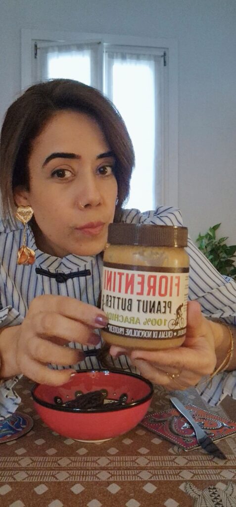 Picture of the author showing a jar of peanut butter.