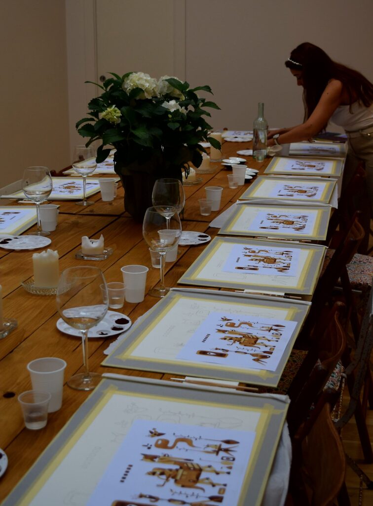 A long table set up for Sip & Dip Painting with Coffee event. 