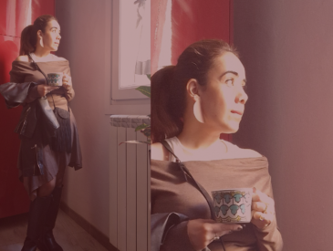 Picture of the author standing in front of a red door, holding a coffee cup.