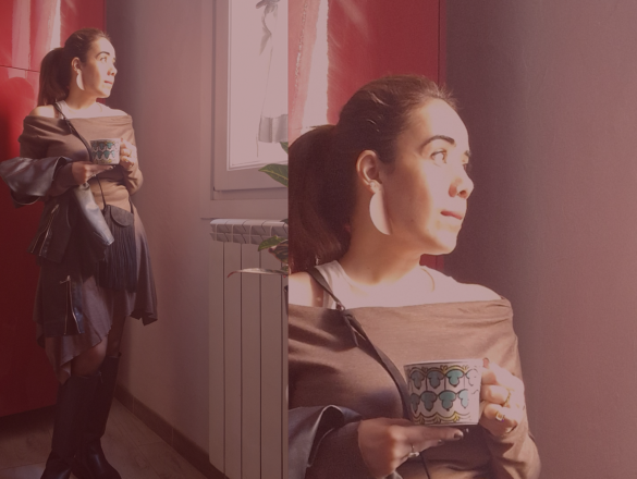 Picture of the author standing in front of a red door, holding a coffee cup.