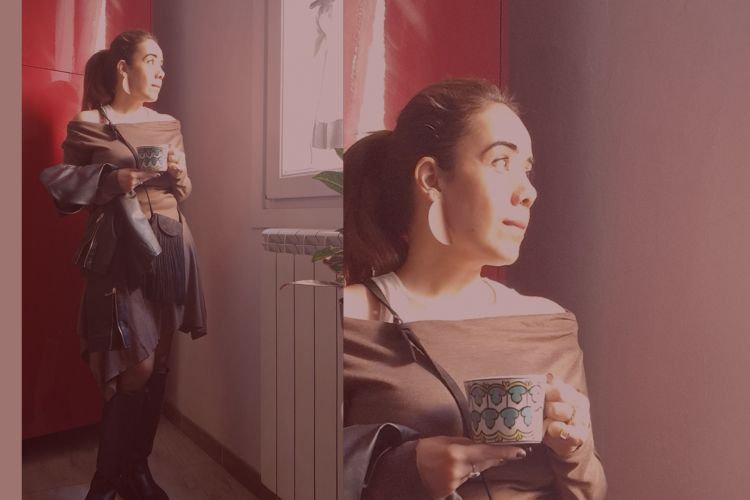 Picture of the author standing in front of a red door, holding a coffee cup.